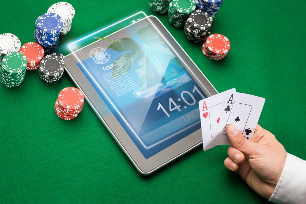 casino poker player with cards, tablet and chips